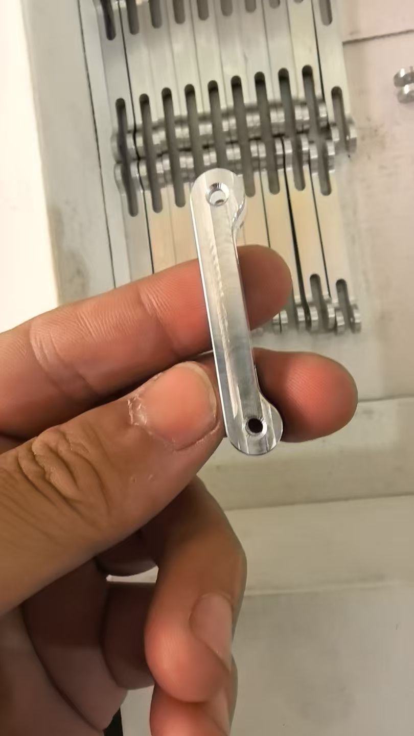 Machined aluminum linkage parts in a batch