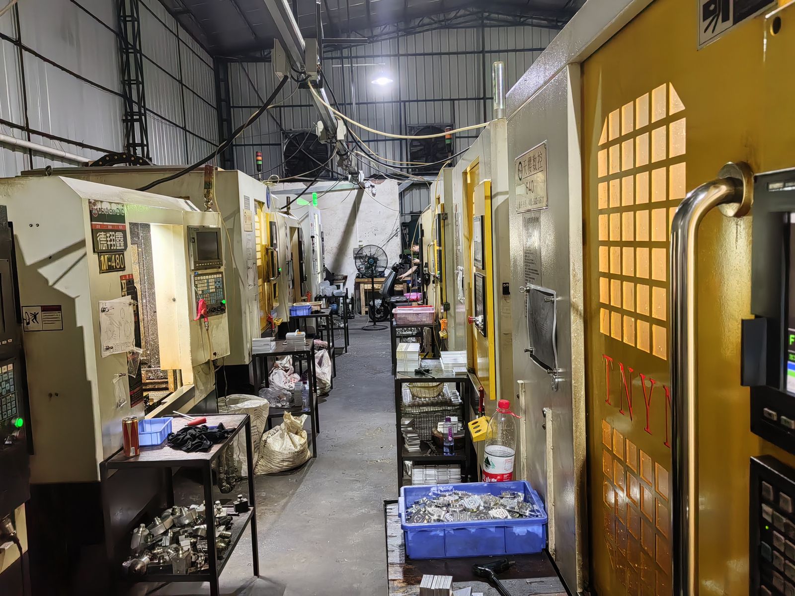 Corridor of CNC machines with chip trays